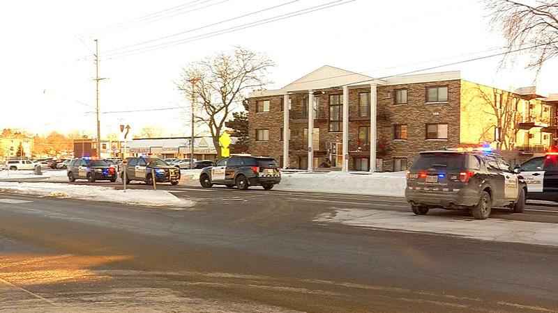 St. Paul police vehicles are parked outside an apartment building during the daytime