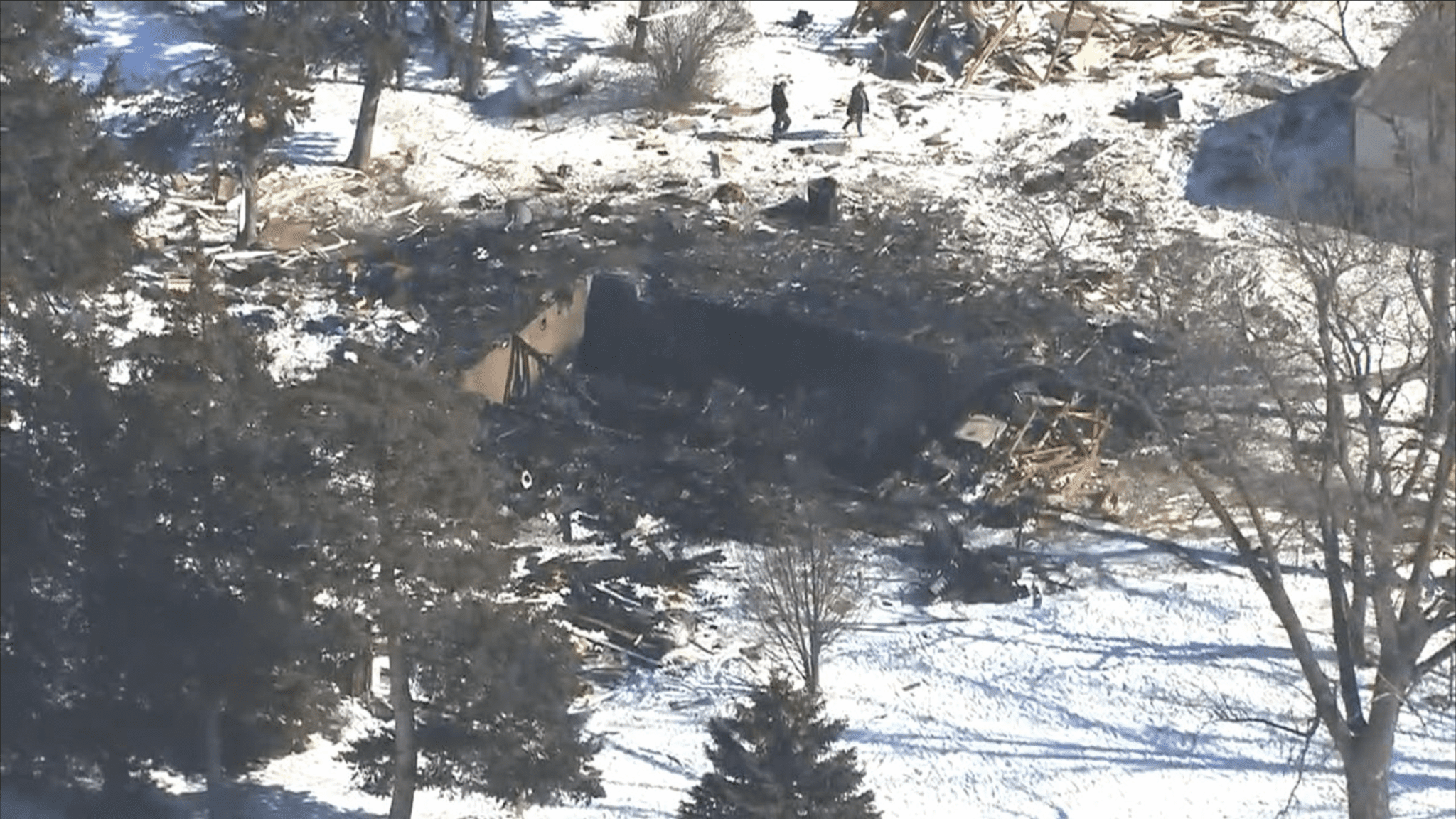 Aerial footage shows the charred remains of a home on Sunday, Feb. 27, 2022, the day after it exploded near Le Center, Minnesota. A deceased woman was found in the basement of the wrecked house.